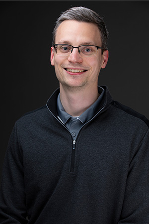 Garrett Gassman, Associate Director of Career Services, smiling in a professional headshot.