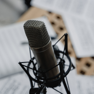 podcast mic with paper blurred in the background