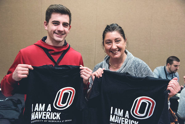 a mom and son hold up uno T-shirts