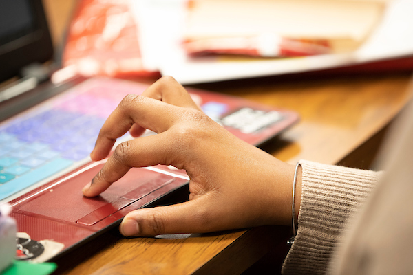 a hand is shown using a laptop